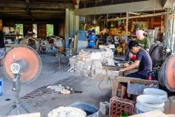 Artisans finishing their finely crafted pottery pieces
