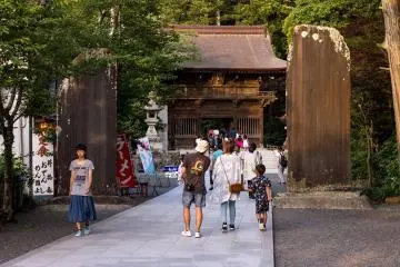 The pathway leading to the main temple gates is flanked by two giant, carved stones