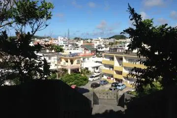 <p>The shrine overlooks the working class Norborikawa neighborhood of northern Okinawa City</p>