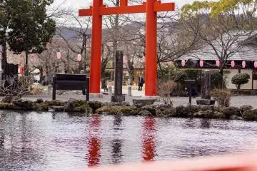 In the eastern part of the shrine grounds you can see one of many large torii on the far side of the Gushing Jewels Pond