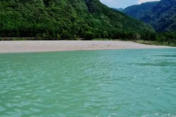 The Kumano River originates in the Kii Mountain Range and it flows into the Pacific Ocean