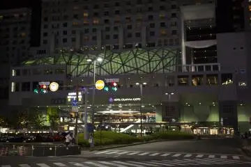 The pale green luminance of the station stands out amongst the more cliché neon glow of a city after dark.
