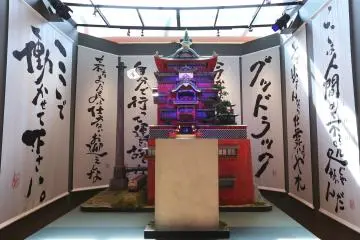 A model of the Aburaya before a backdrop of Suzuki's calligraphy (Photo: <a href="https://suzukitoshio-ghibli.com/" target="_blank" rel="noreferrer noopener nofollow">Toshio Suzuki and Ghibli Exhibition</a>)