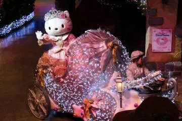 Hello Kitty waves to her adoring audience as she rides away in a chariot at the end of the performance.