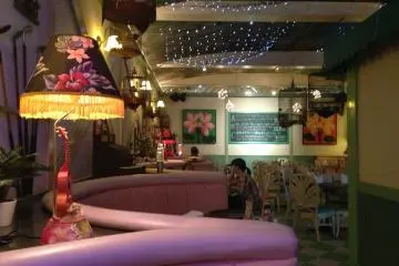 <p>The dining area is brightly colored and romantic, and includes seating in other colors if pink doesn't tickle you</p>