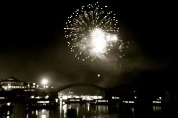 black and white shot shows a classic river scene in firework light