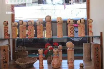 Kokeshi display in the window of Naruko Onsen Station