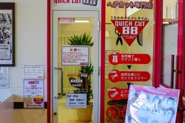 A barber tucked away in the entrance to Max Value