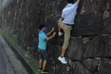 The steep walls of the castle were meant to keep out ruthless warriors. Let's hope they can keep curious Japanese children out too!