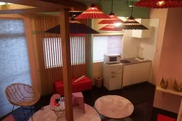 The living area connects to mini fridge and kitchen.