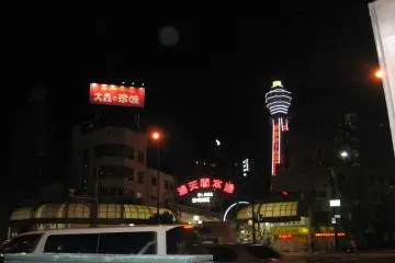 The south end of Den Den Town ends at an entrance to Shinsekai, with a view of Tsutenkaku Tower.