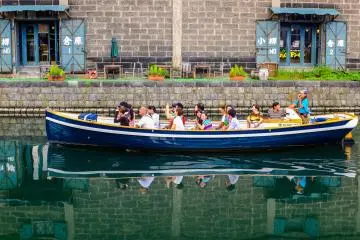Reflections of the Otaru Beer hall and excited tourists