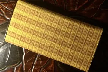 The distinctive check pattern on this wallet highlights the yellow threads