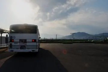 The bus stop is just outside the shopping complex.