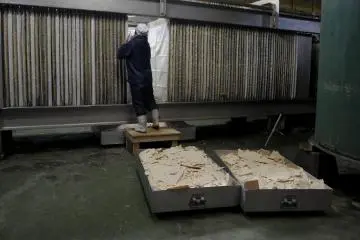At Tokun Sake Brewery, a worker is extracting sake less, a bi-product from sake brewing. (Only viewable in winter on special days)