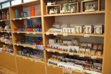 <p>There's a nice little selection of shisha dogs and Ryukyuan stained glass inside Partnerhip Shop and Cafe</p>
