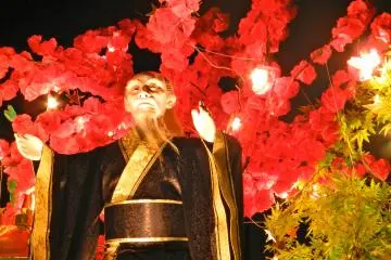 Wizards watch from the tops of floats as they parade around the city.