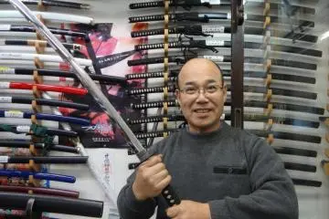 Sankai-do's owner, Kamegaya-san, holding a Samurai sword.