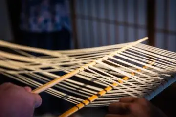 The traditional way: udon noodles are separated with wooden sticks before hanging to dry