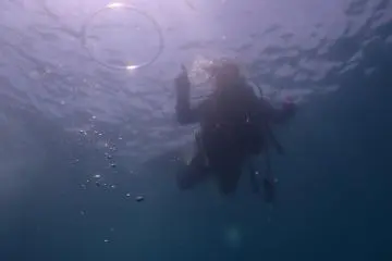 The instructor has fun too. He blows a ring of air towards the sun. 