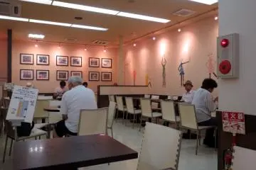 The non-smoking section of the store with people busy at work or rest