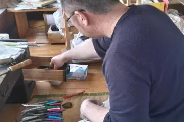 A grumpy craftsman polishing his blades