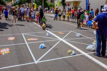 Children enjoying a game of "Roll the potato" to win a prize