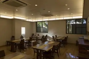 The dining room offers a humble environment while eating with a quaint little garden outside the window
