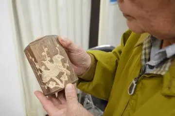 A local craftsman admires his work