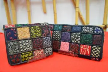 Wallets created using a patchwork of traditional Japanese motifs patterned in inden (lacquered deerskin leatherwork)