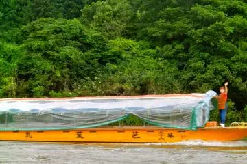 Boats cruise up and down the river.