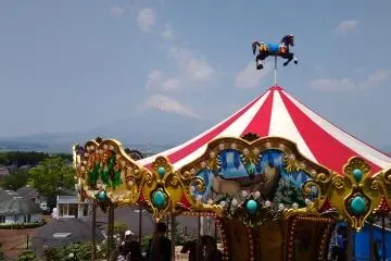 The love seat is situated in front of the carousel which also has a view of the mountain.