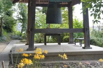 Even the bell tower has a thatched roof