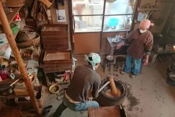 my host father while smashing rice