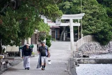 A torii leads to a sacred shrine and koi pond at Cape Ose