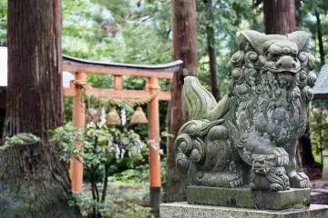 A lion guards this torii in Hakone