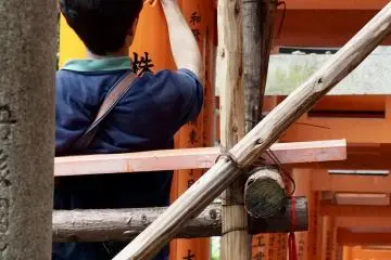 A torii is kept in shape at Fushimi Inari Taisha