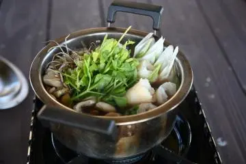 Nabekko hot pot with kiritanpo simmering alongside the veggies
