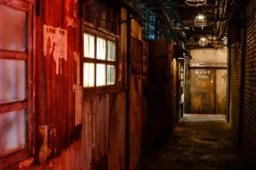 You’re immediately immersed in a dark and dingy alleyway constructed with the look and feel of the original Kowloon Walled City