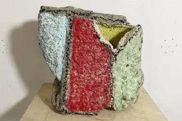 Rie Shinno's works incorporate various objects like rocks and crayons