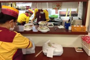 <p>There's usually only one employee in the front of the store; food preparation takes place in the busy kitchen behind the sales counter</p>