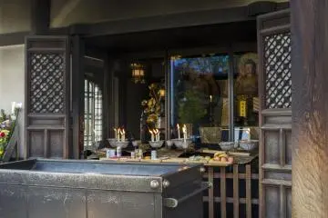 Two of the Okotsu Butsu and the offering people have placed before them at Isshinji Tennoji