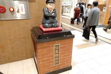 "Lucky God" Sendai Shiro wearing a JR train employee uniform.
