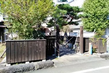 The rock is housed in a fenced off section of a residential neighborhood