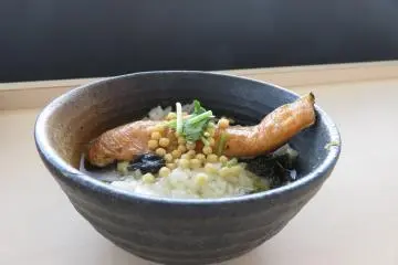 Ochazuke is a signature dish at Mikaku. They age the salmon for three days, and grill it, skin on, to maximise its flavor.