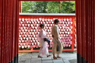 The shrine has heart shaped ema, plus rows of torii arches
