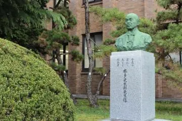A statue of Kotaro Honda (1870-1954) guards the front garden.