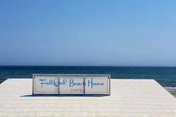 In front of the beach houses, the big blue
