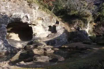 Meditation cave in the rock garden overlooking the pond