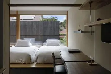 Simply designed bedroom on the second floor (Photo: Kishi-ke)